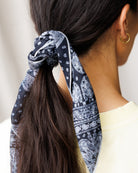 Image of woman wearing a scarf in their hair