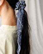 Image of a woman wearing a scarf in their hair