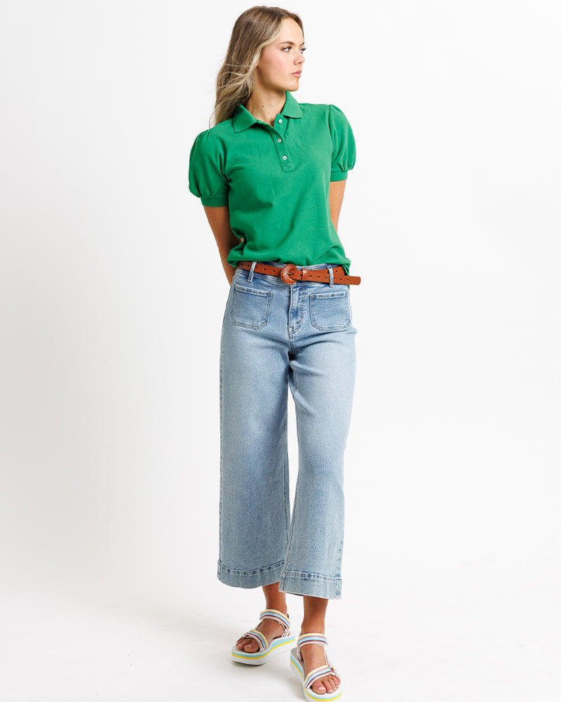 Model wearing blue wide leg, cropped, light blue denim jeans.