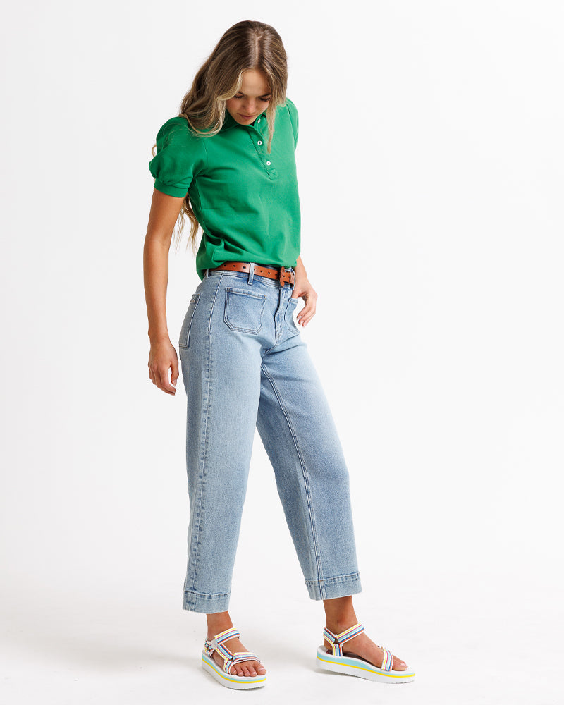 Model wearing blue wide leg, cropped, light blue denim jeans.