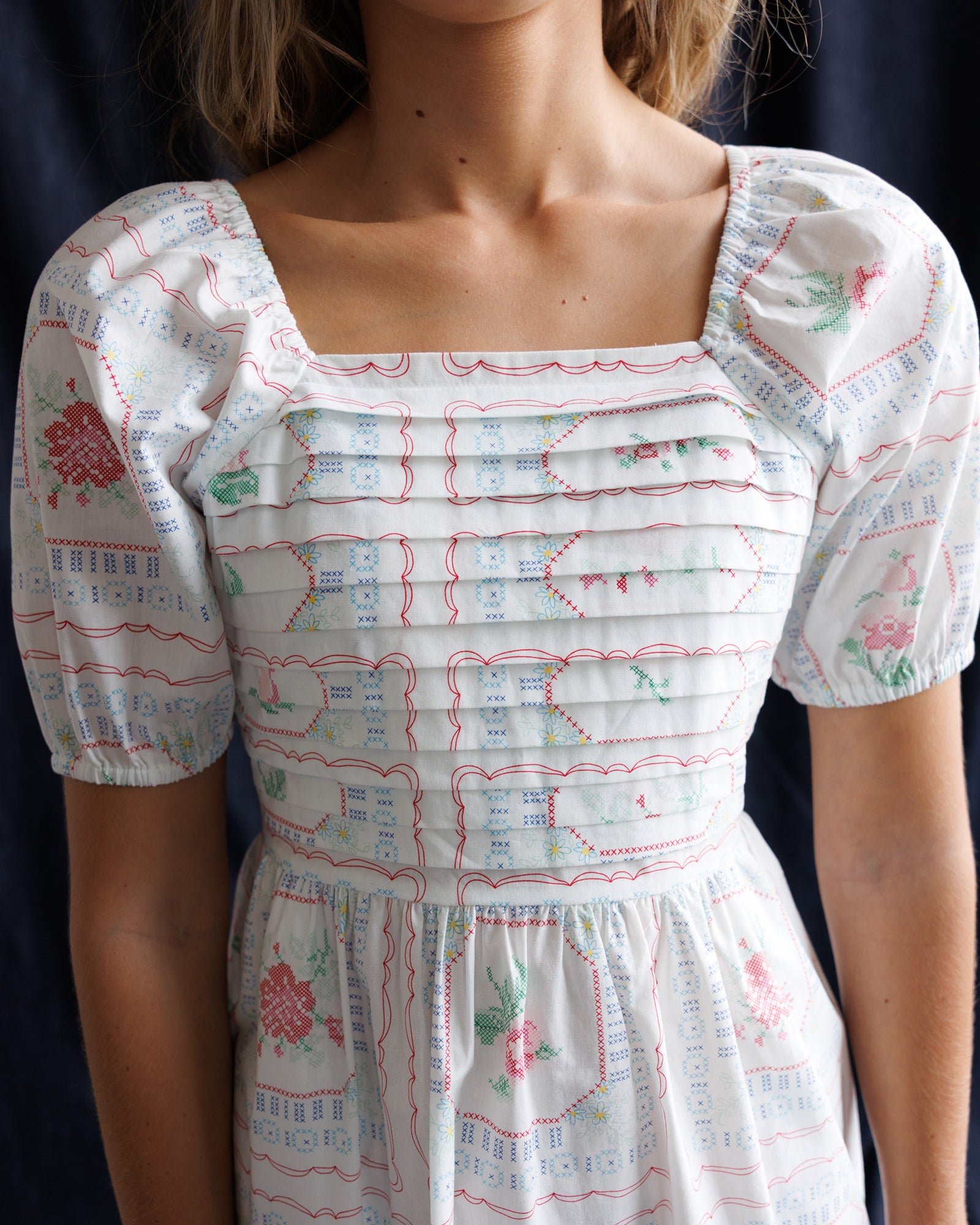 White dress with floral pattern on a plain background