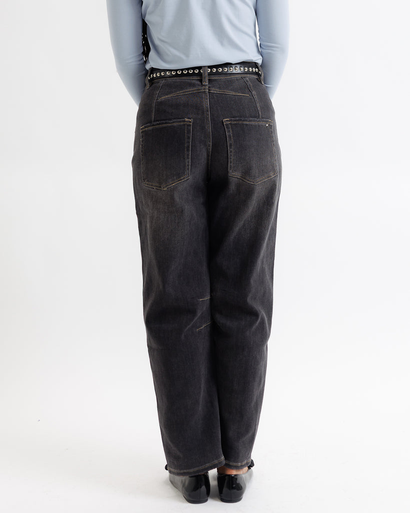 Person wearing black jeans on a white background