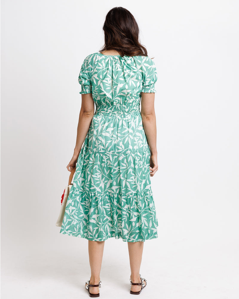 Model wearing a mint green with white floral print short sleeve round neck midi dress