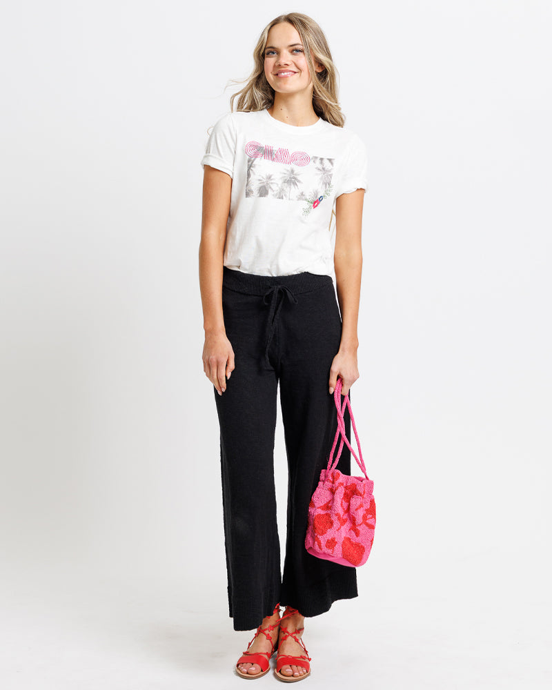 Model wearing a pair of black cropped knit pants
