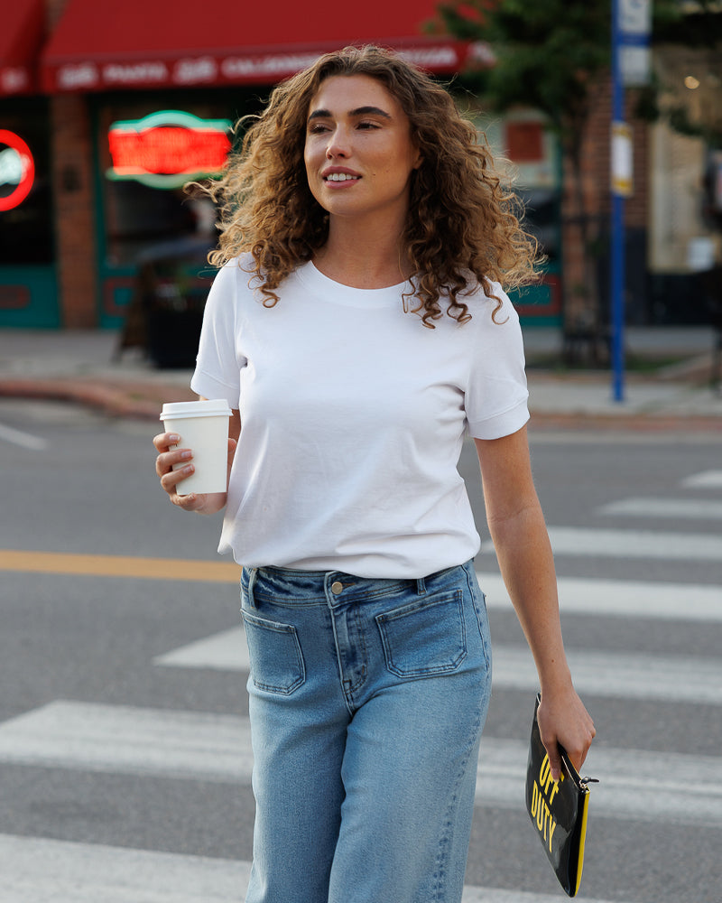 Model wearing a white short sleeve basic t-shirt