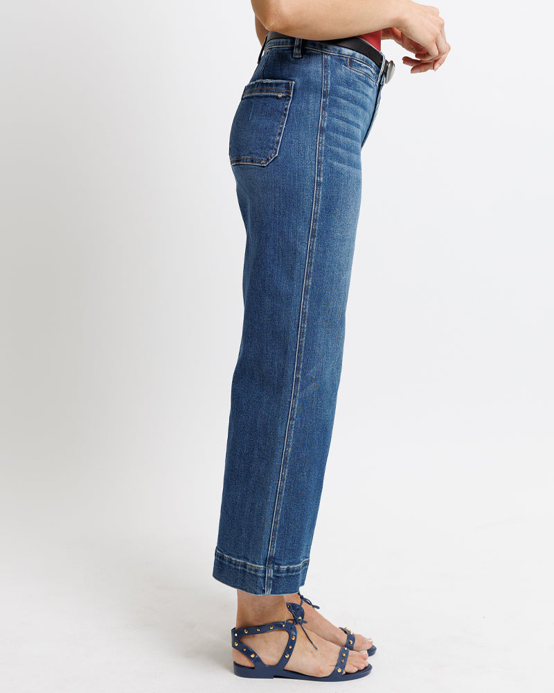 Model wearing dark blue mid-rise wide leg cropped jeans.
