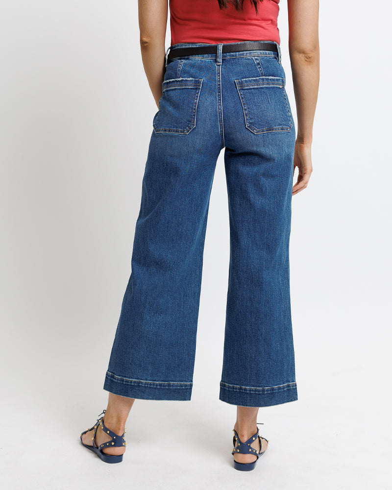 Model wearing dark blue mid-rise wide leg cropped jeans.