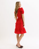 Woman wearing a red dress on a white background