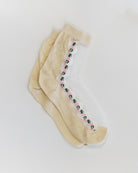 Beige tights with floral design on a white background