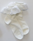 White socks with lace top on a light gray background