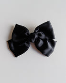 Black bow on a light gray background
