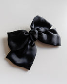 Black bow on a light gray background