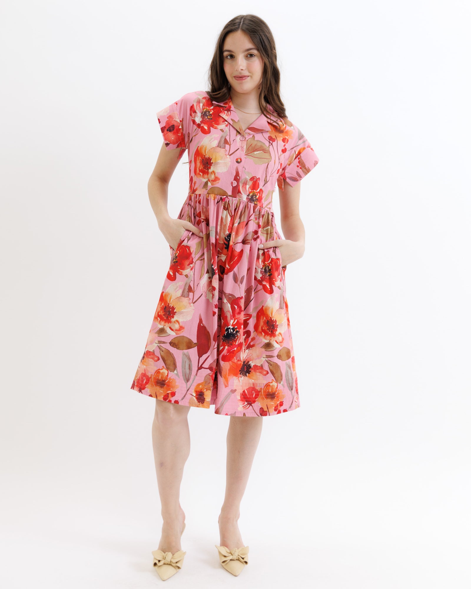 Woman wearing a floral dress on a white background