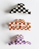 Set of three checkered hair clips on a white background