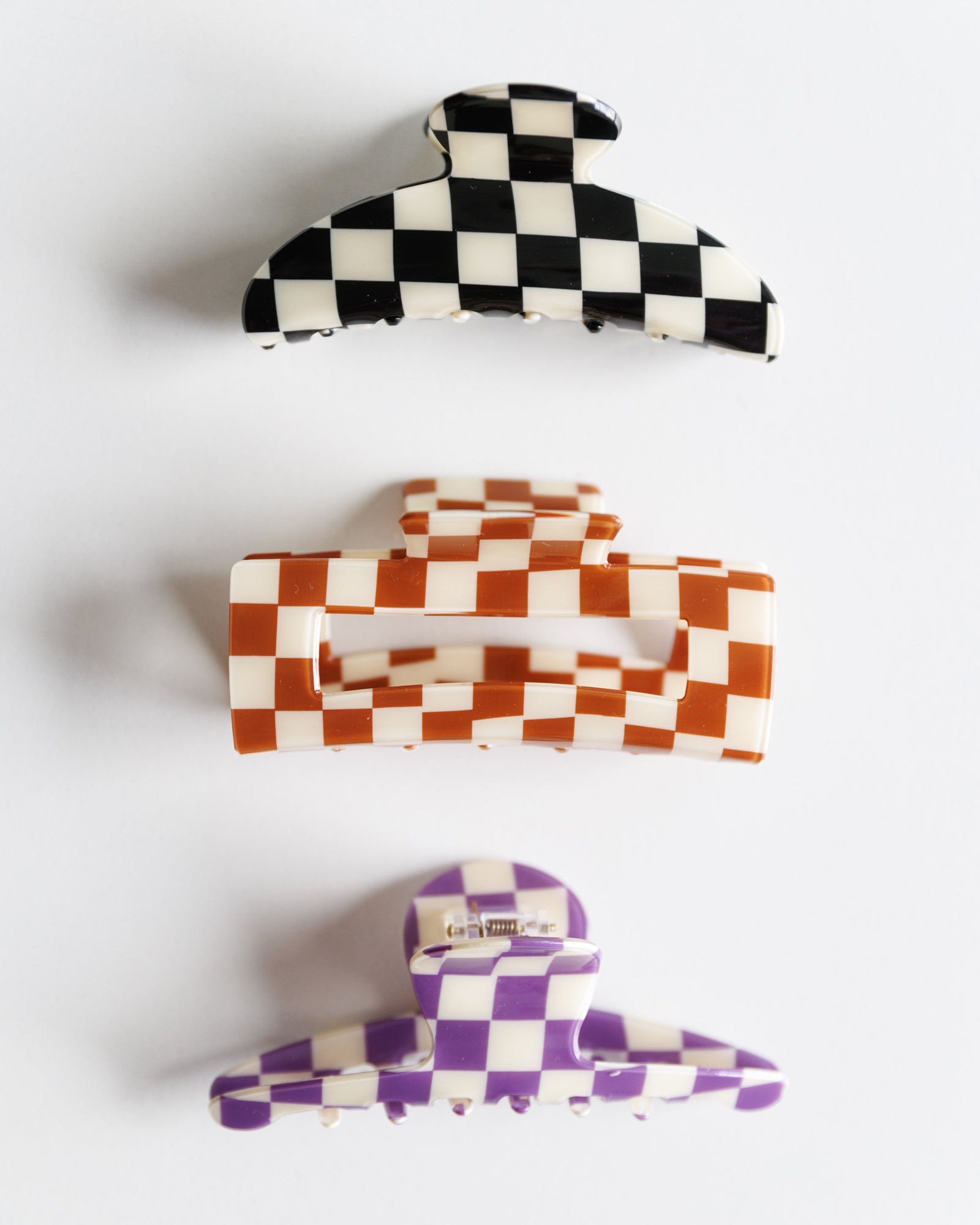 Set of three checkered hair clips on a white background