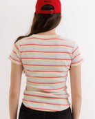 Person wearing a striped shirt and red cap on a white background