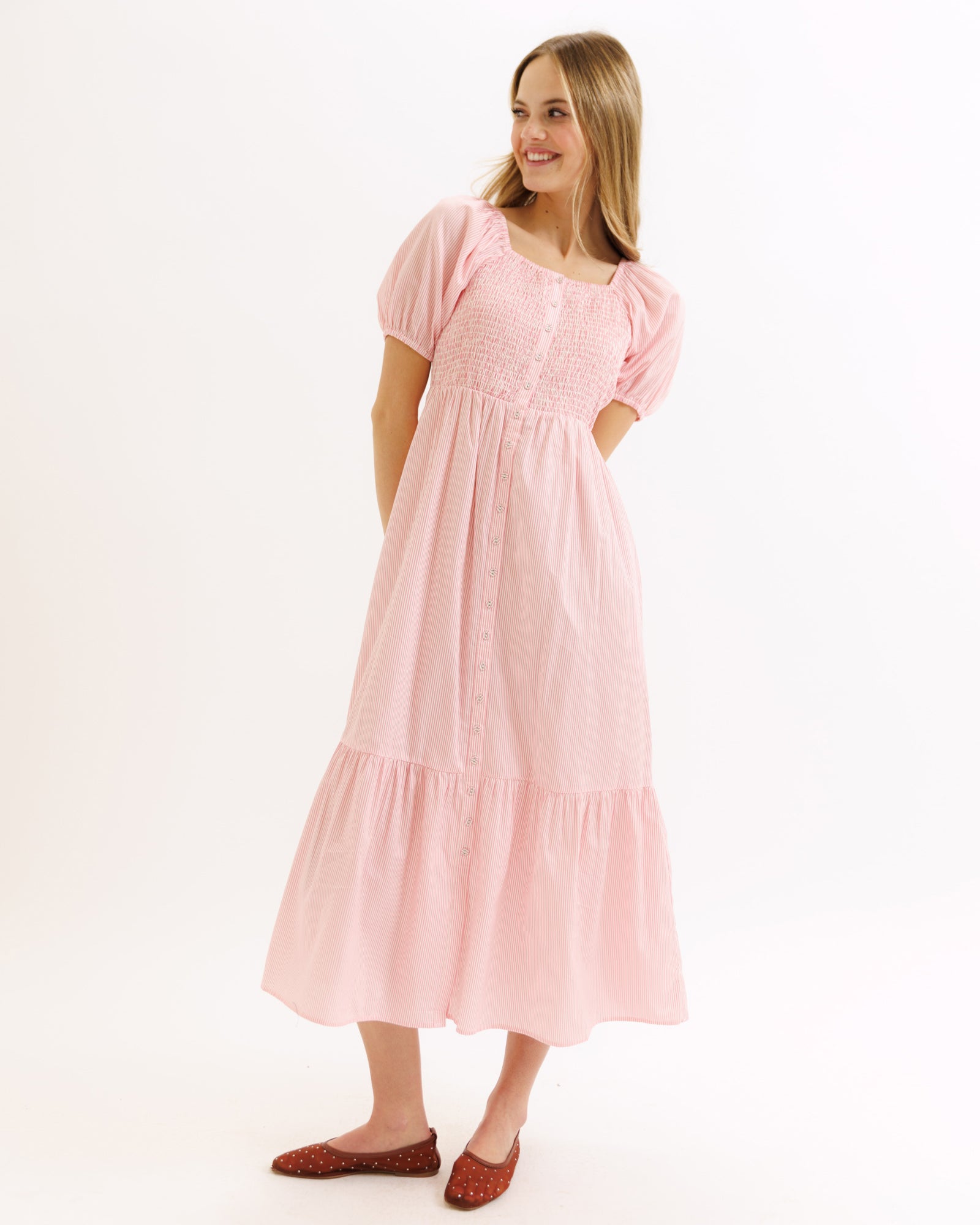 Woman wearing a pink dress on a white background