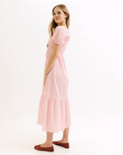 Woman wearing a pink dress on a white background