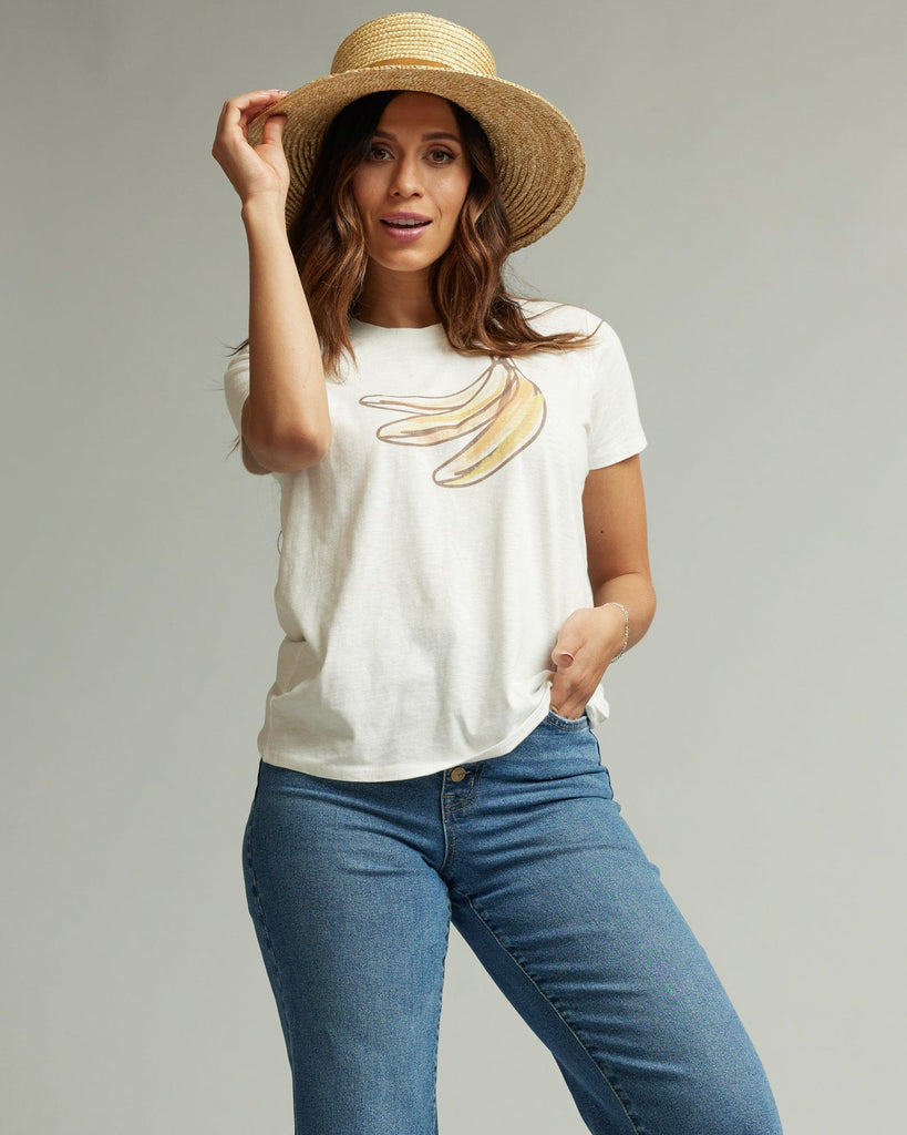 Woman in a short sleeve white graphic tee with a banana on the front