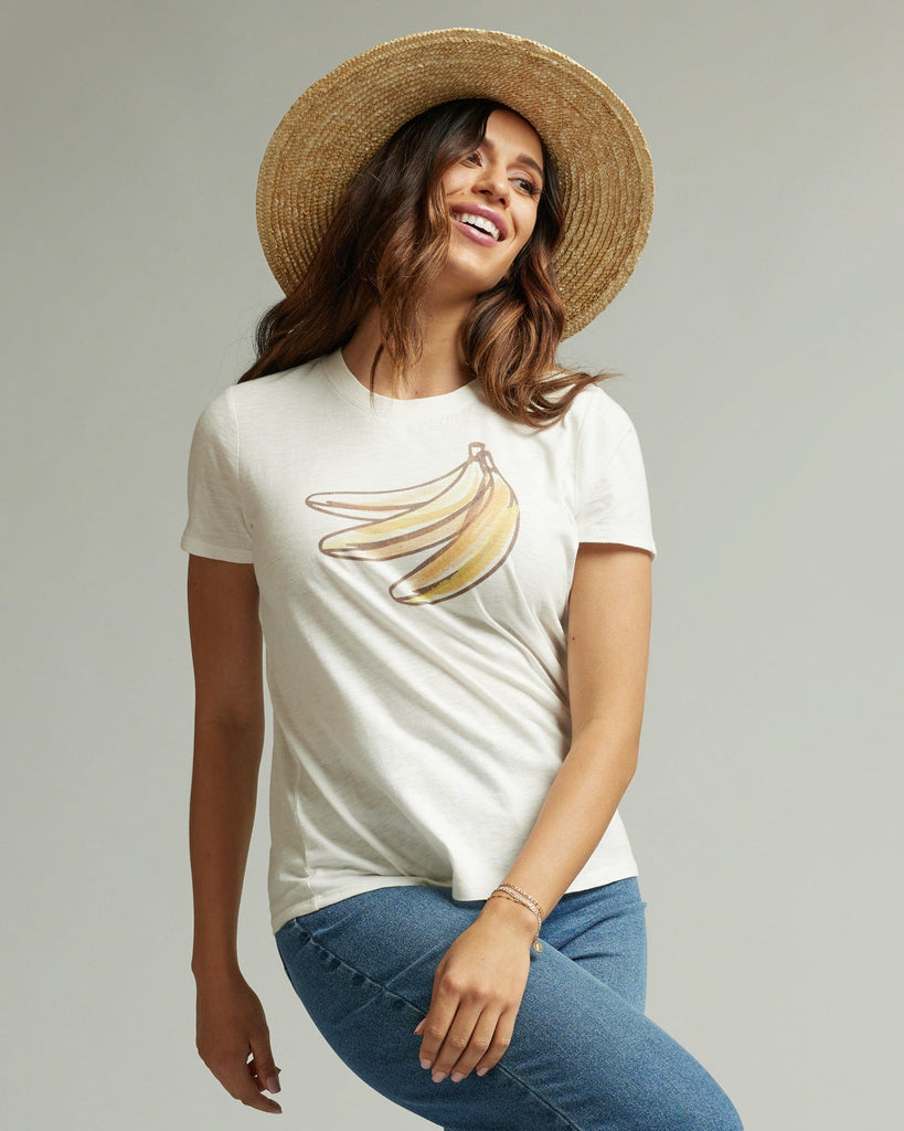 Woman in a short sleeve white graphic tee with a banana on the front