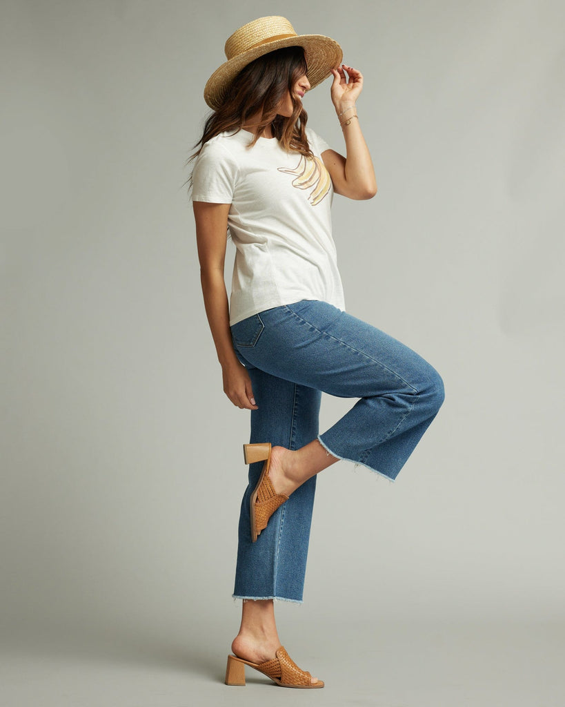 Woman in a short sleeve white graphic tee with a banana on the front