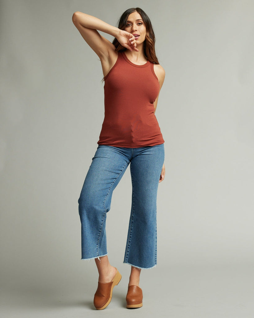 Woman in sleeveless, fitted, high neck, basic tank top