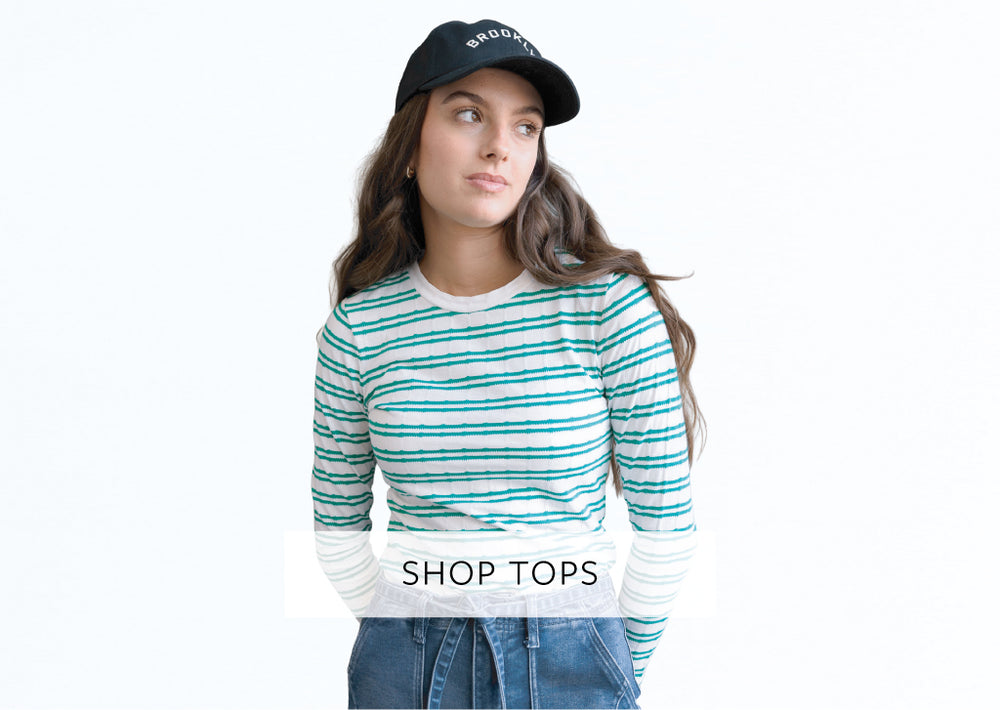 Woman wearing a striped shirt and cap with 'Brooklyn' text, on a white background.