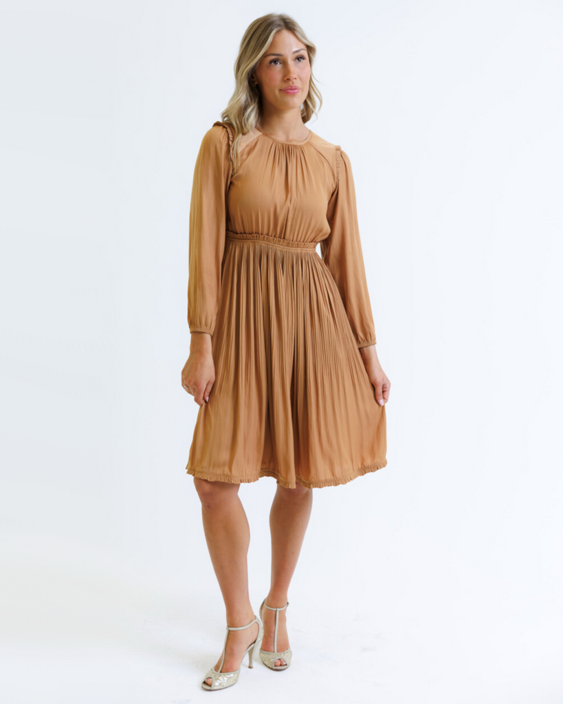 Woman wearing an orange knee-length dress on a white background