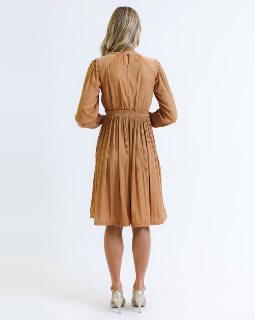 Woman wearing an orange knee-length dress on a white background