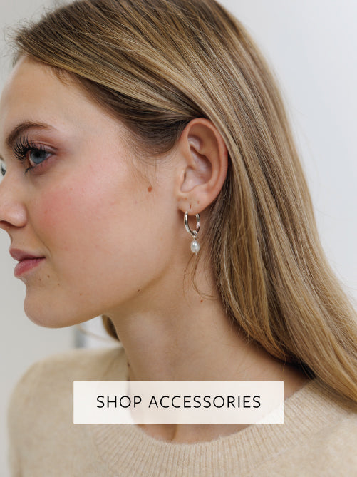 Close-up of a woman wearing earrings with a 'Shop Accessories' text overlay.