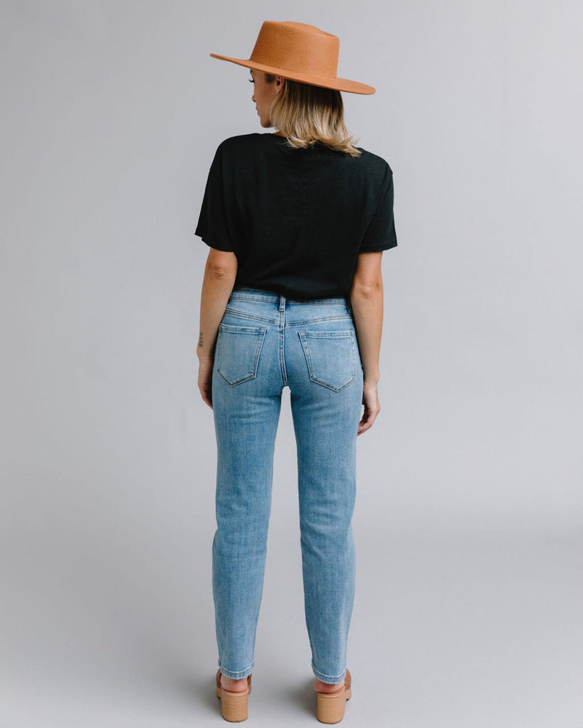 Woman in blue mid-rise straight jeans