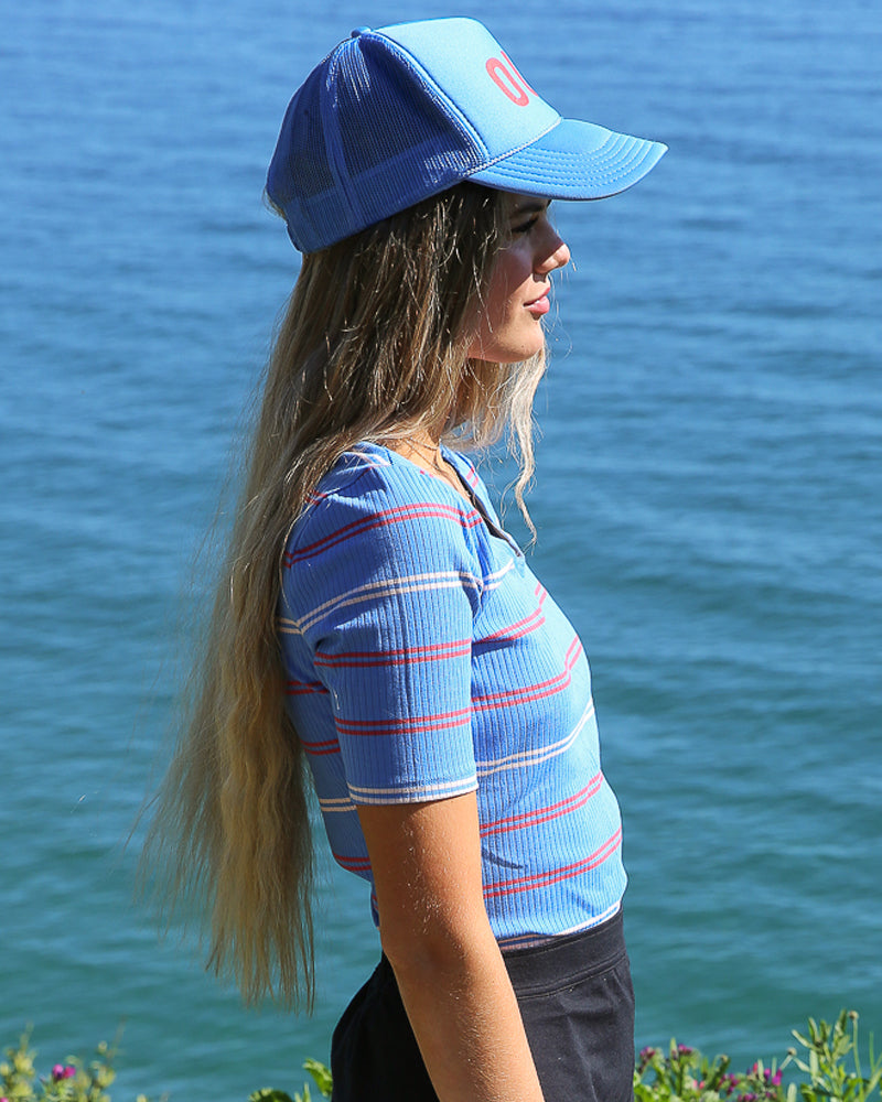 Model wearing a blue with white and red striped half sleeve scoop neck t-shirt