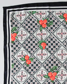 Fabric with black and white geometric pattern and red fruit design
