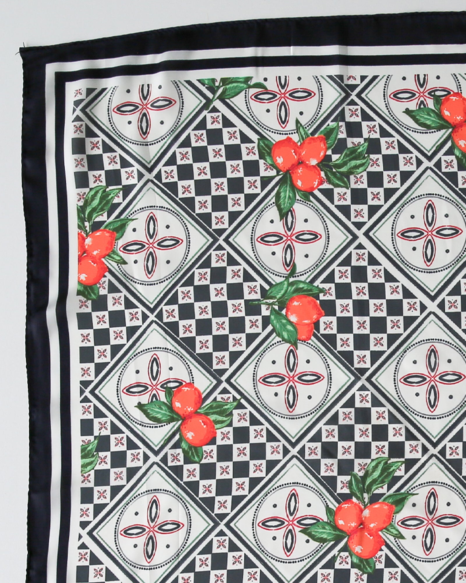 Fabric with black and white geometric pattern and red fruit design