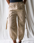 Beige cargo pants worn by a person on a plain background
