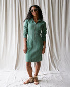Woman wearing a green dress against a white background