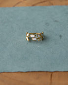 Gold ring with white stones on a blue surface