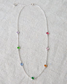 Necklace with colorful beads on a light gray background