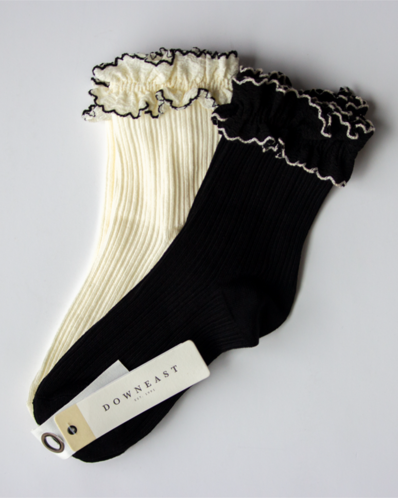 Black and white ruffled socks with 'Downeast' label on a light gray background