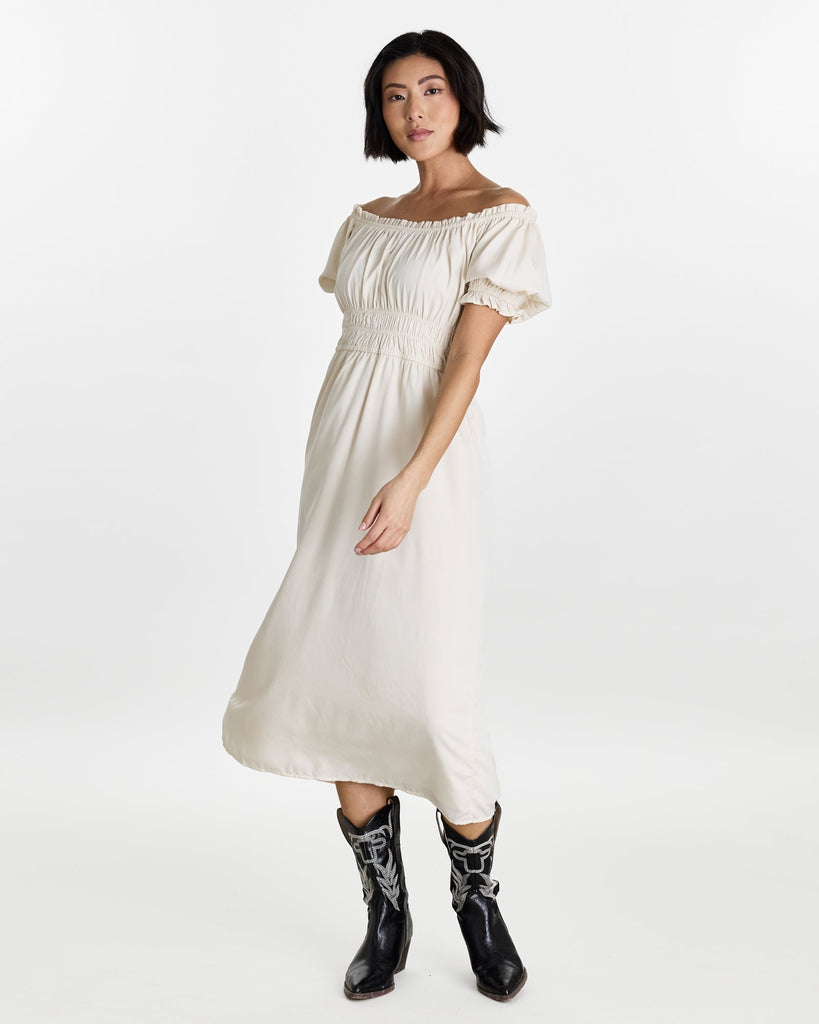 Woman in a short sleeve, off the shoulder, midi-length dress