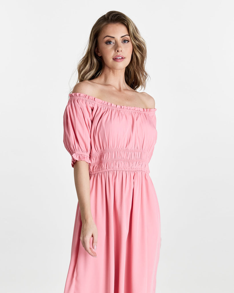 Woman in a short sleeve, off the shoulder, midi-length dress