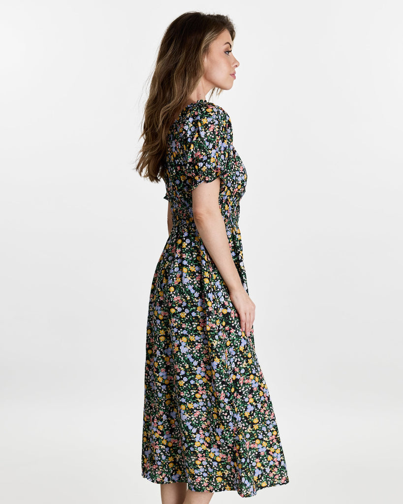 Woman in a short sleeve, off the shoulder, midi-length dress