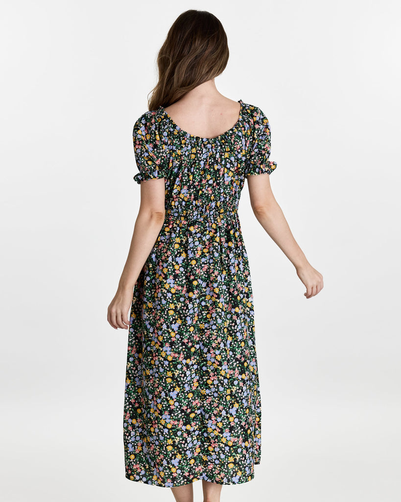 Woman in a short sleeve, off the shoulder, midi-length dress