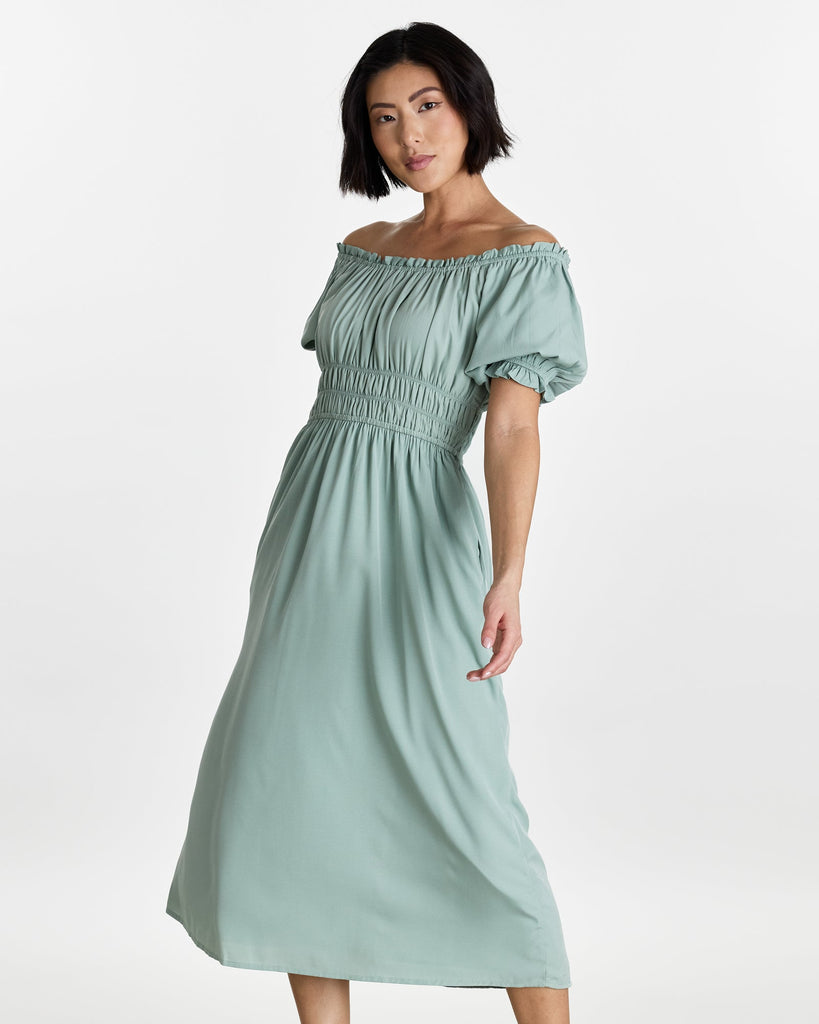 Woman in a short sleeve, off the shoulder, midi-length dress