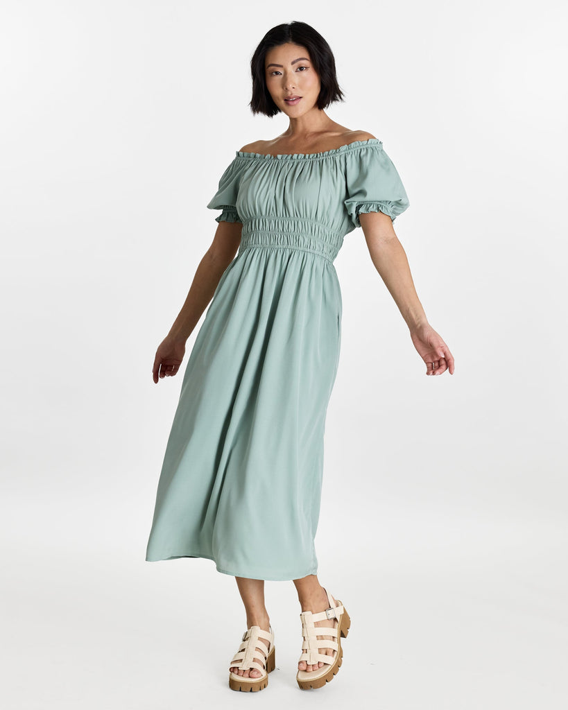 Woman in a short sleeve, off the shoulder, midi-length dress