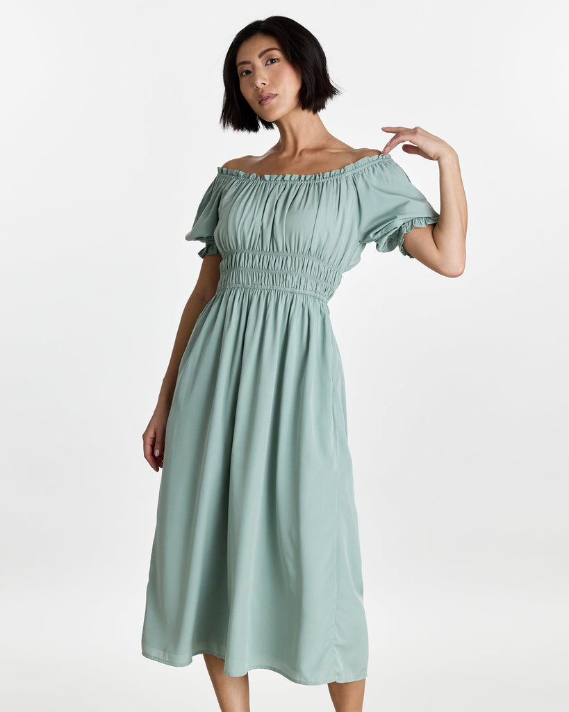 Woman in a short sleeve, off the shoulder, midi-length dress