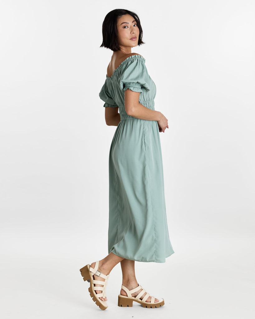 Woman in a short sleeve, off the shoulder, midi-length dress