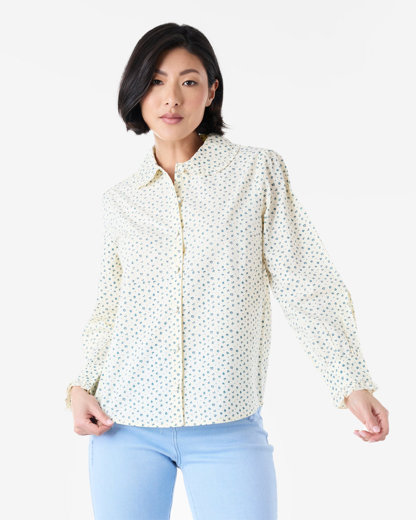 Woman in a white and blue long sleeve, collared, button-down