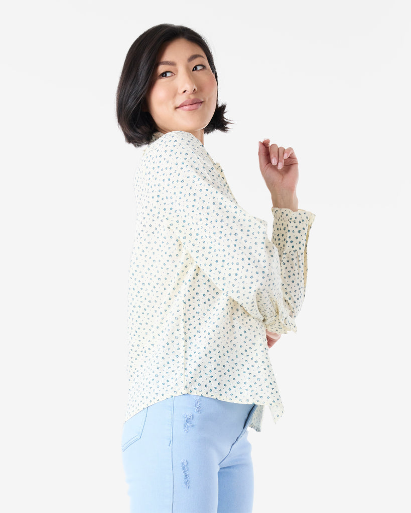 Woman in a white and blue long sleeve, collared, button-down