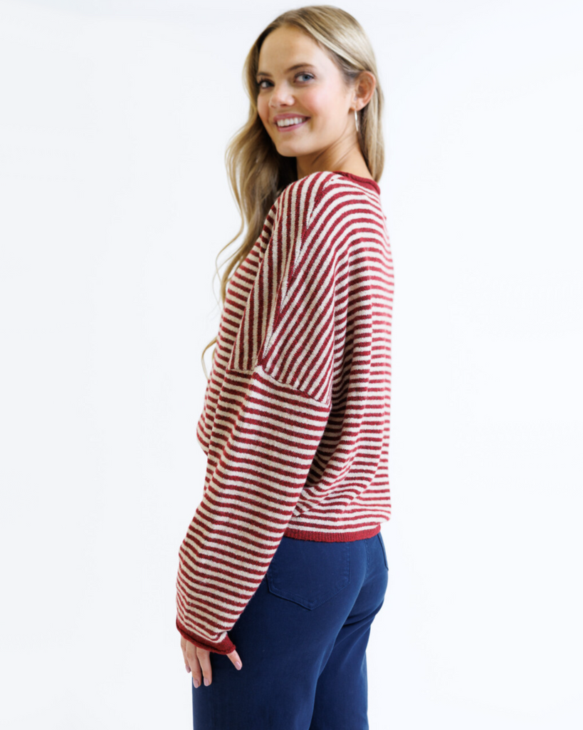 Woman wearing a red and white striped sweater on a white background